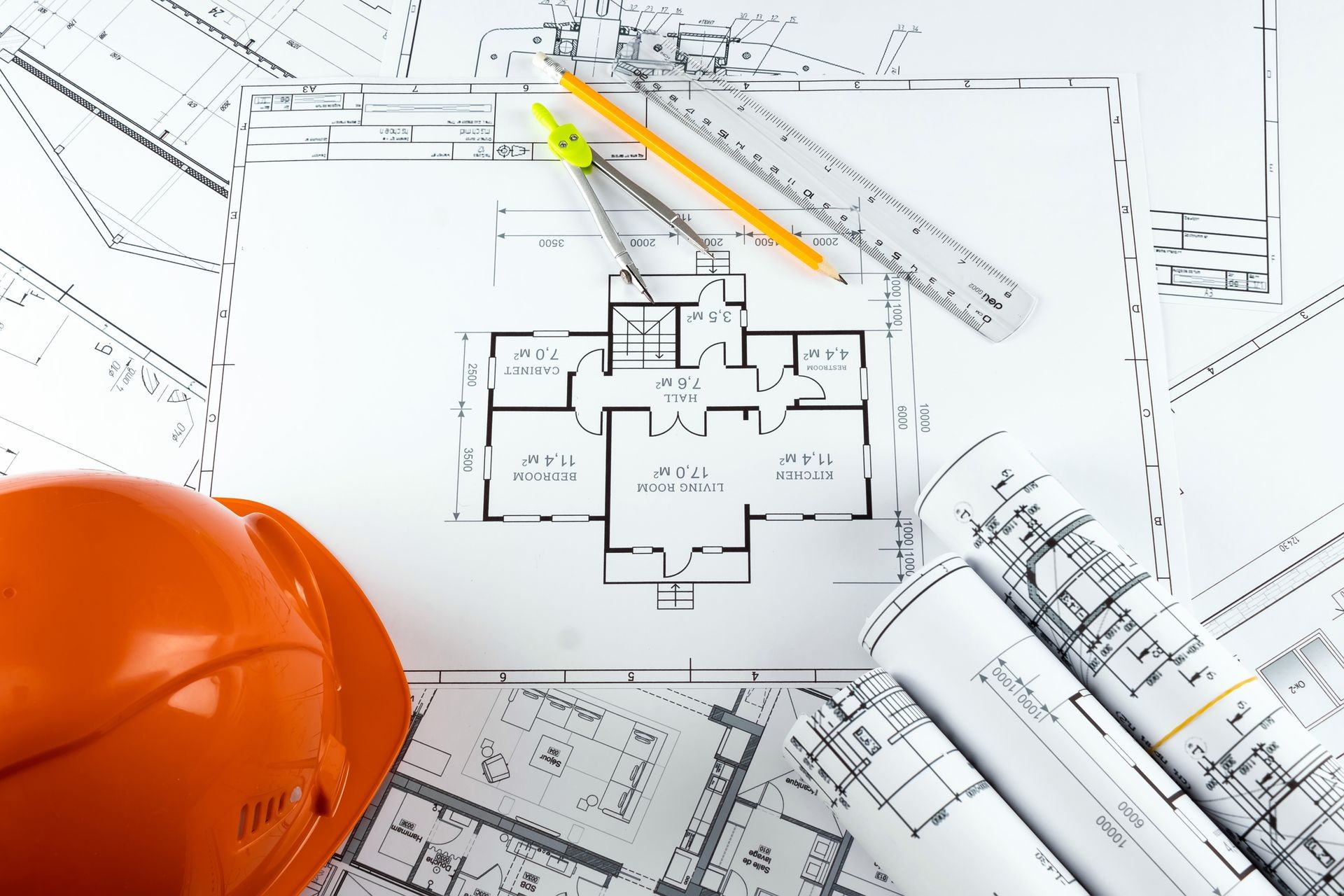 Orange helmet, pencil, architectural construction drawings, tape measure. The concept of architecture, construction, engineering, design. Copy space. Orange helmet, pencil, architectural construction drawings, tape measure. The concept of architecture, construction, engineering, design. Copy space.