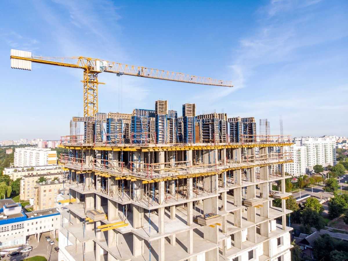 construction of new apartment building. construction site with tower cranes and scaffolding. aerial view